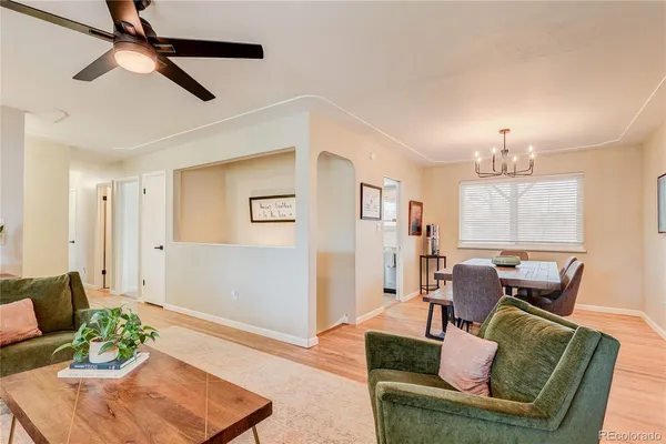 a living room with furniture and a chandelier