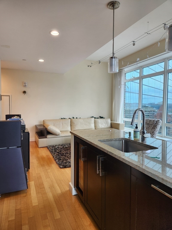 400 Stuart Street, Unit 18K Boston, MA 02116 - Photo 14 of 31 a kitchen with sink and view of living room