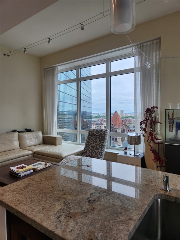 400 Stuart Street, Unit 18K Boston, MA 02116 - Photo 15 of 31 a living room with furniture and large windows