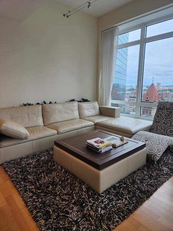 400 Stuart Street, Unit 18K Boston, MA 02116 - Photo 16 of 31 a living room with furniture and a large window
