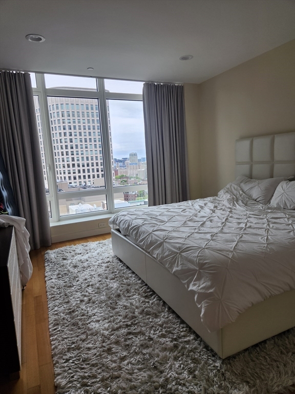 400 Stuart Street, Unit 18K Boston, MA 02116 - Photo 17 of 29 a bedroom with a bed and a large window