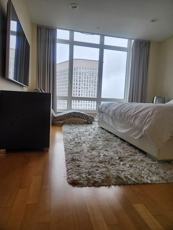 400 Stuart Street, Unit 18K Boston, MA 02116 - Photo 19 of 31 a living room with a bed furniture and a large window