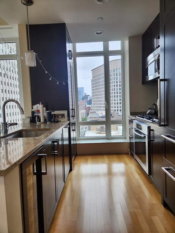 400 Stuart Street, Unit 18K Boston, MA 02116 - Photo 10 of 31 a kitchen with sink window and stainless steel appliances