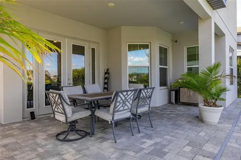 a view of a patio with a dining table and chairs