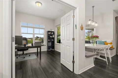a view of a dining room with furniture window and wooden floor