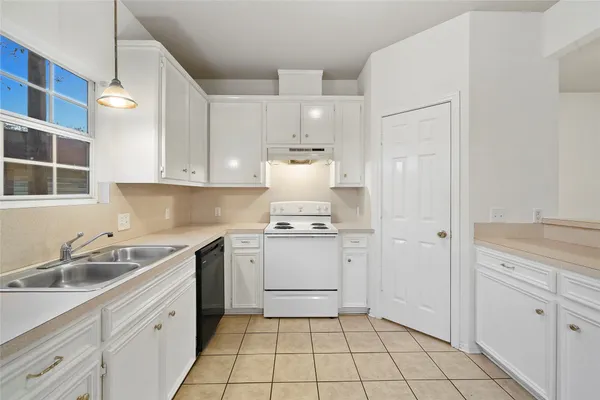a kitchen with a sink cabinets and window