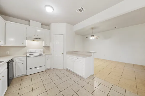a kitchen with cabinets and appliances