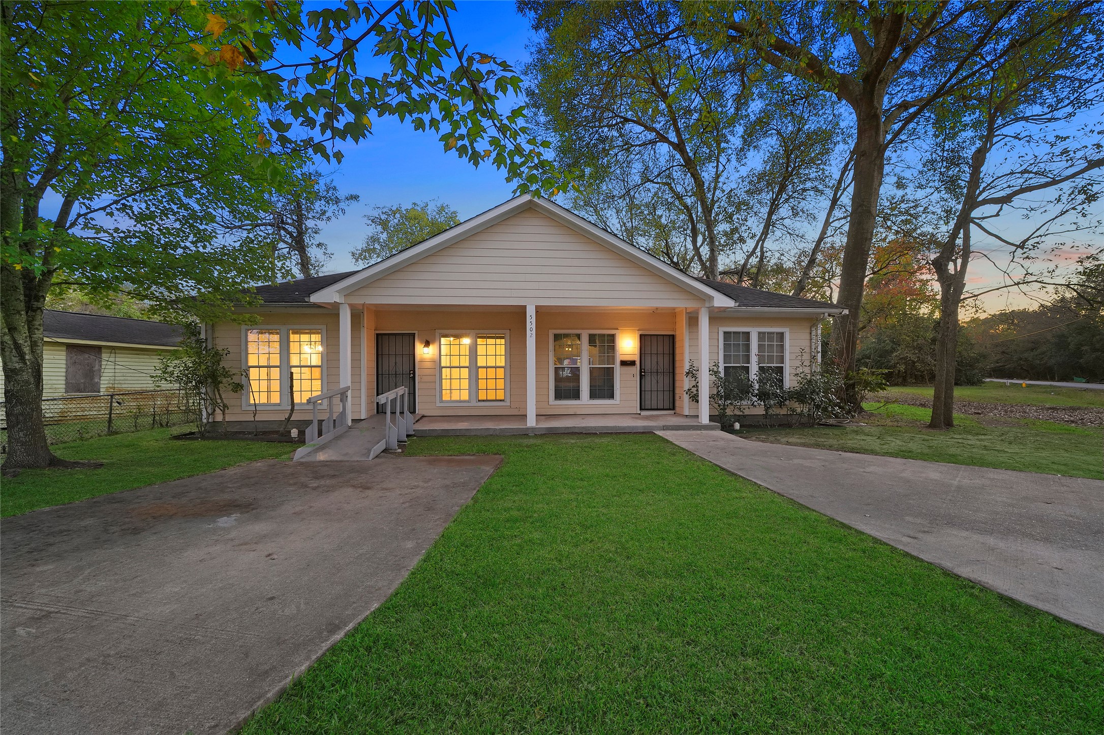 5502 Finch Street, Unit B Houston, TX 77028 - Photo 2 of 37 a front view of a house with yard and green space