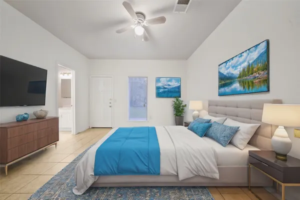 a spacious bedroom with a bed and a flat screen tv