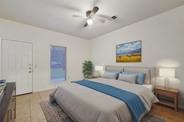 a bedroom with a bed and a chandelier