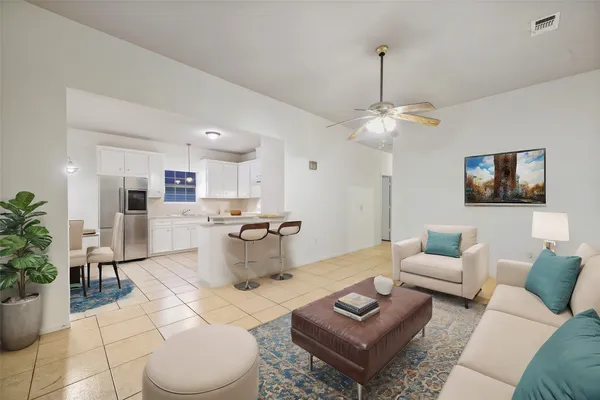 a living room with furniture a rug and a chandelier