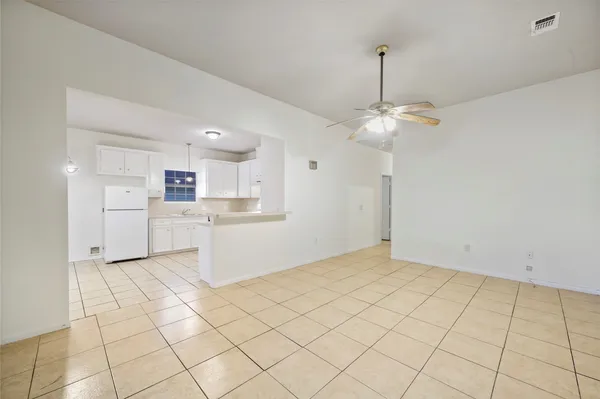 a kitchen with white cabinets and white appliances