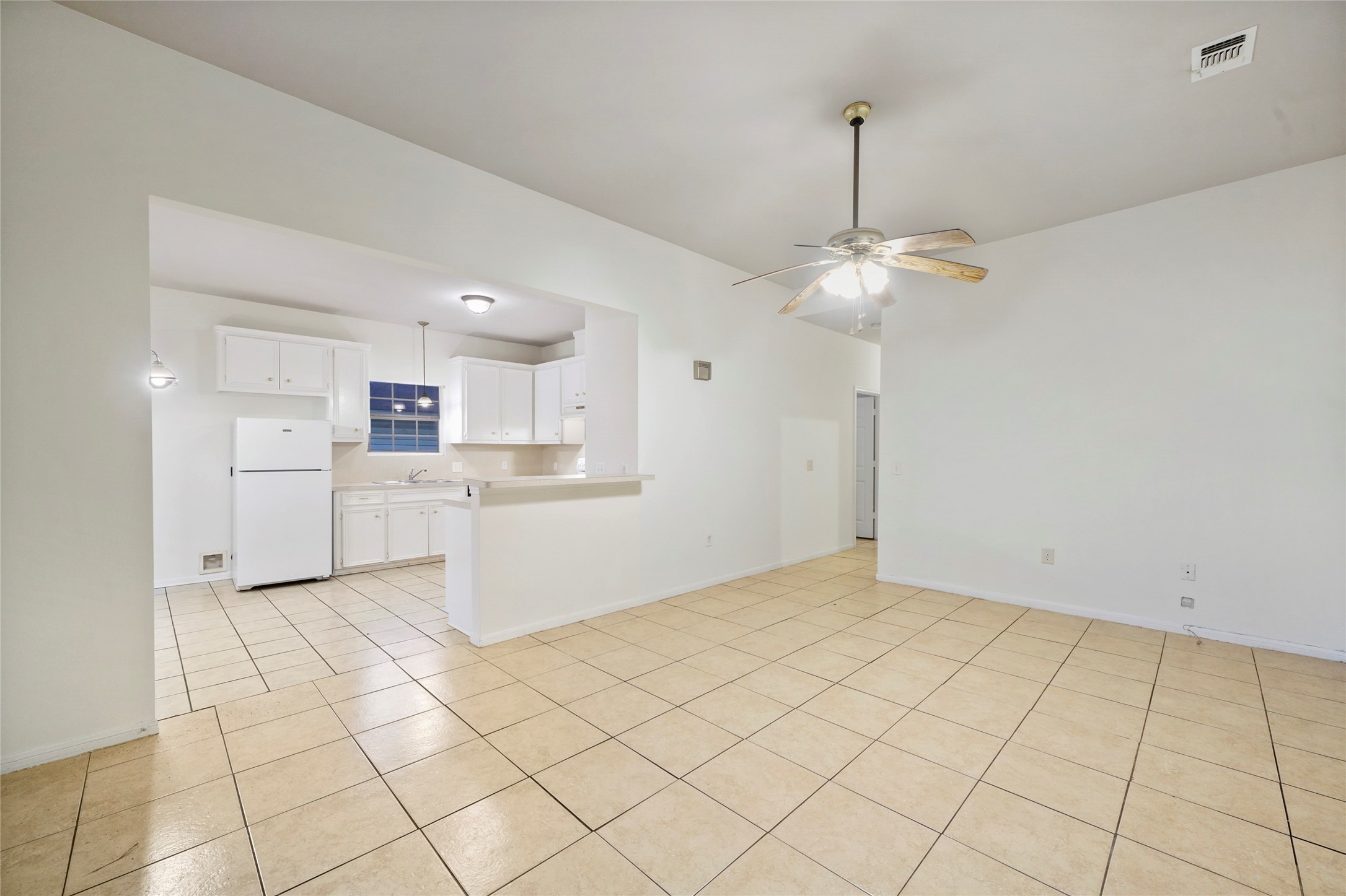 5502 Finch Street, Unit B Houston, TX 77028 - Photo 4 of 37 a kitchen with white cabinets and white appliances