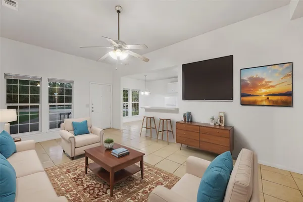 a living room with furniture a rug and a flat screen tv