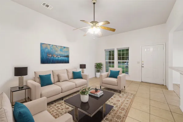 a living room with furniture a rug and a window