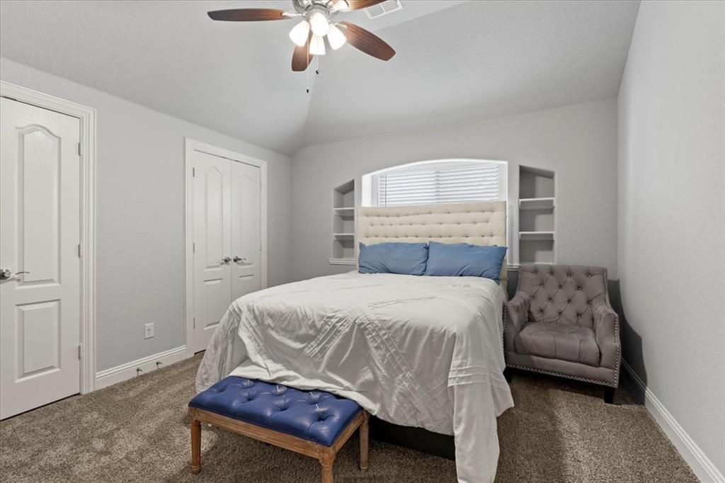 620 Shadow Trail Frisco, TX 75033 - Photo 26 of 36 Bedroom featuring neutral-toned walls, vaulted ceiling, and carpet flooring