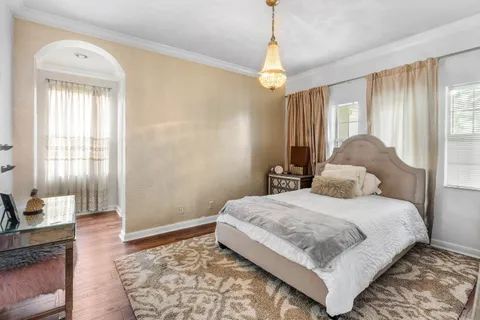 a bedroom with a large bed and a window