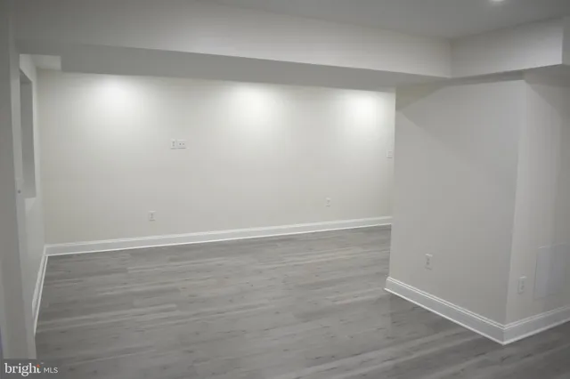an empty room with wooden floor and closet