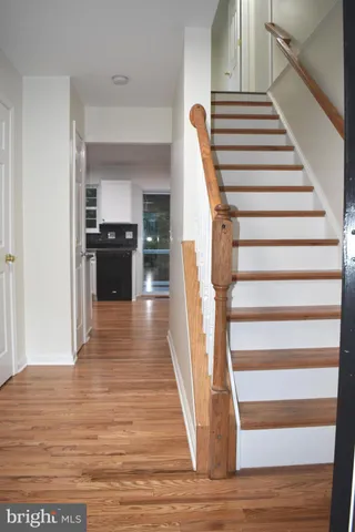 a view of entryway and hall with wooden floor
