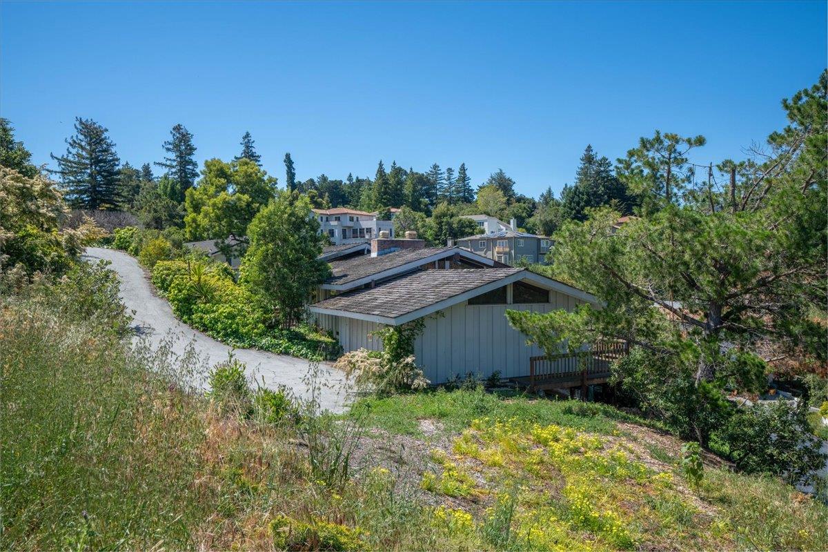 2760 Summit Drive Burlingame, CA 94010 - Photo 6 of 20 a view of a garden with a building in the background