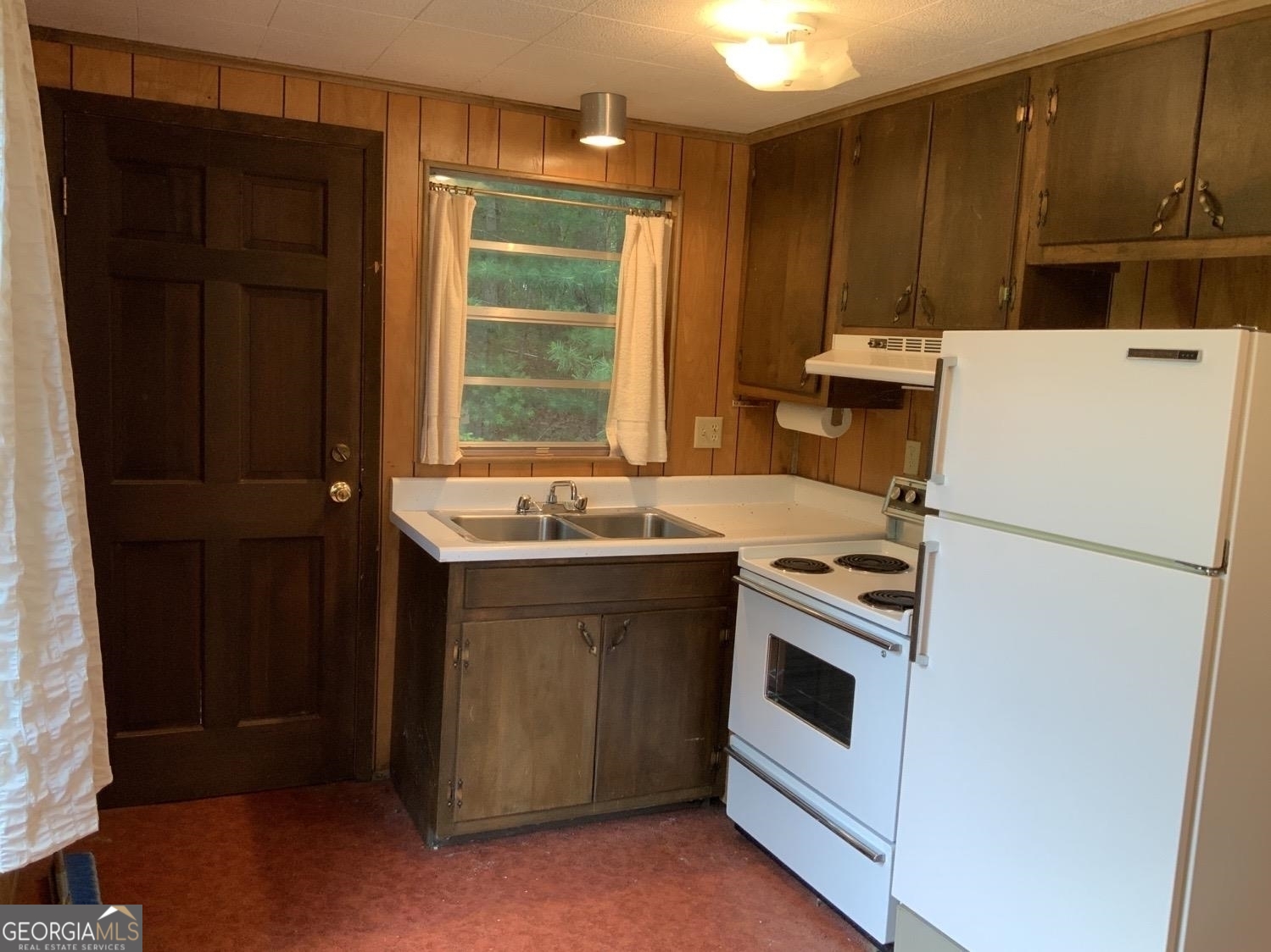 277 Hamilton Road Blairsville, GA 30512 - Photo 14 of 27 a kitchen with a stove sink and cabinets