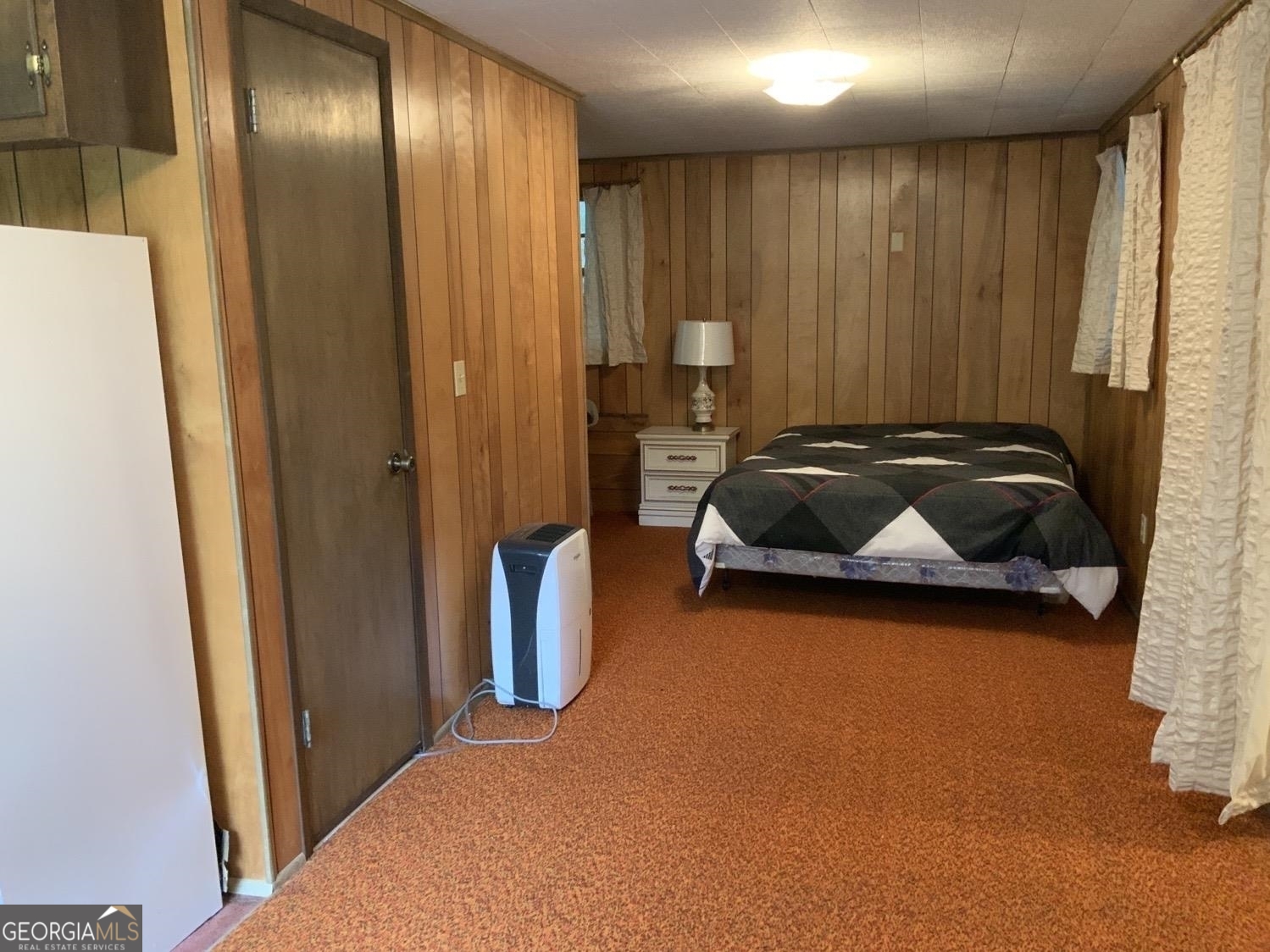 277 Hamilton Road Blairsville, GA 30512 - Photo 16 of 27 a bedroom with a bed and a mirror