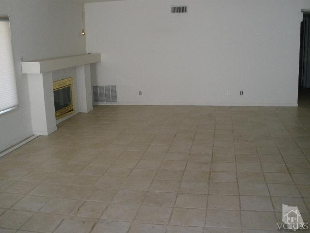 2693 Bancock Street Simi Valley, CA 93065 - Photo 3 of 6 an empty room with a fireplace
