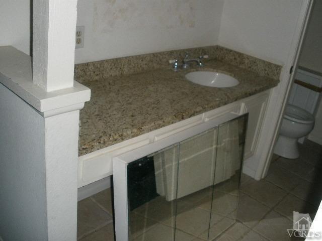 2693 Bancock Street Simi Valley, CA 93065 - Photo 5 of 6 a bathroom with a granite countertop sink and a mirror
