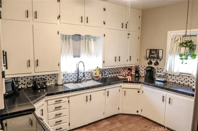 a bedroom with a bed a mirror and lamp on desk