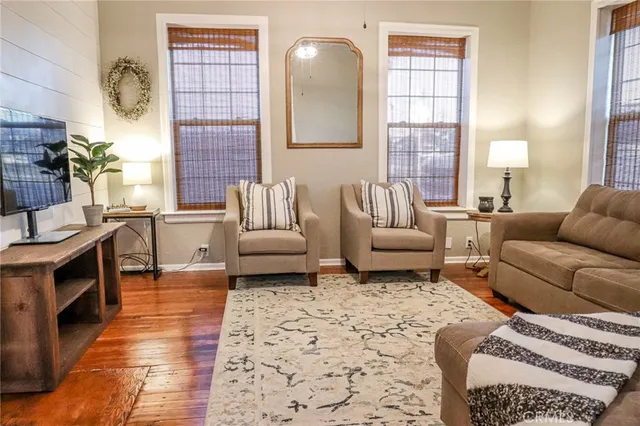 a living room with a bed furniture and a window