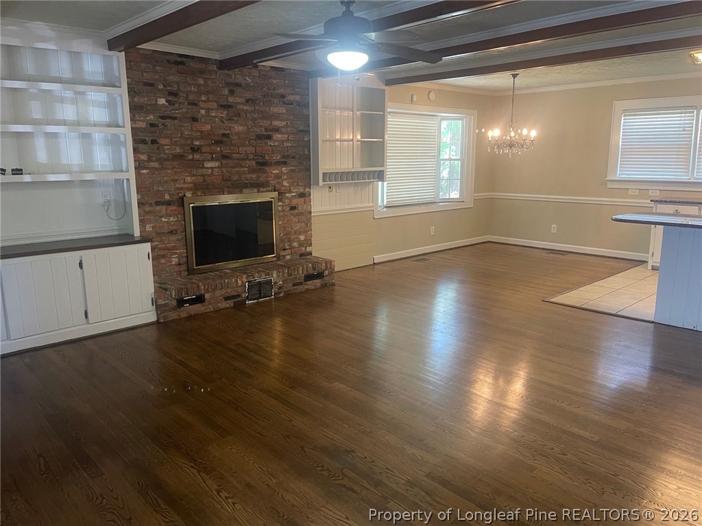 2515 Fort Bragg Road Fayetteville, NC 28303 - Photo 4 of 23 a view of an empty room with wooden floor and a fireplace