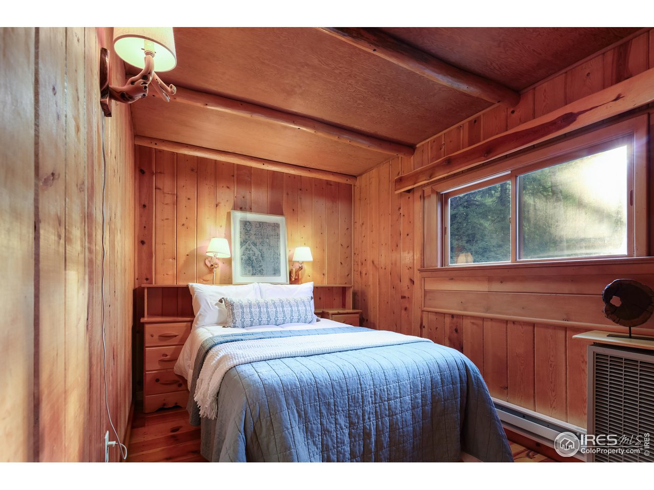 3443 Riverside Drive Lyons, CO 80540 - Photo 35 of 40 a bedroom with a bed and a large window