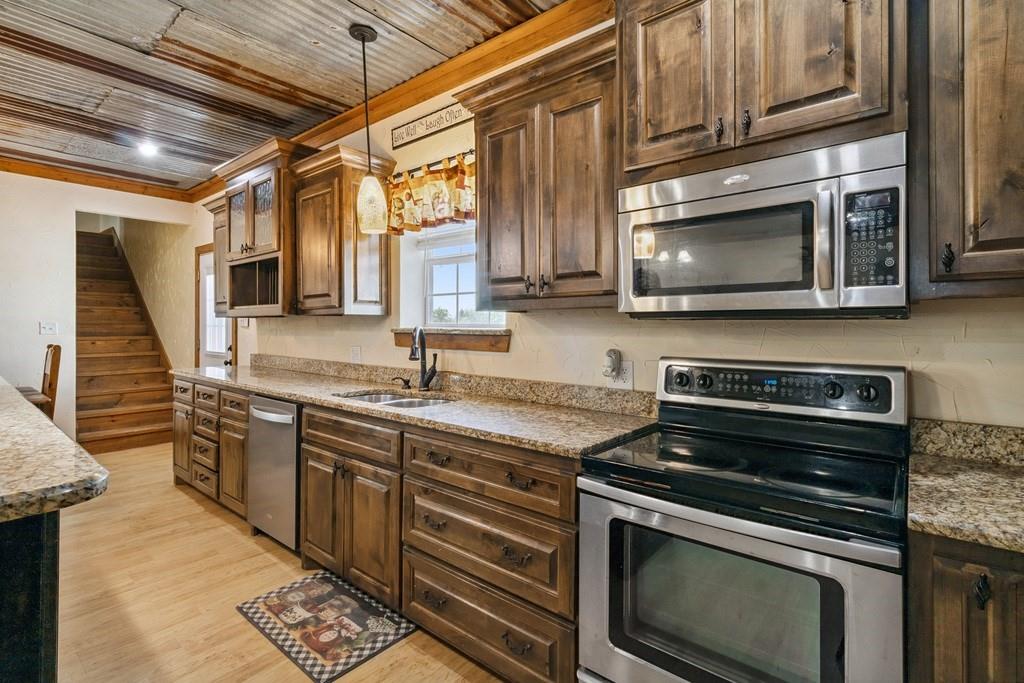 800 County Road 2807 Mabank, TX 75147 - Photo 12 of 40 a kitchen with stainless steel appliances granite countertop a stove microwave and sink