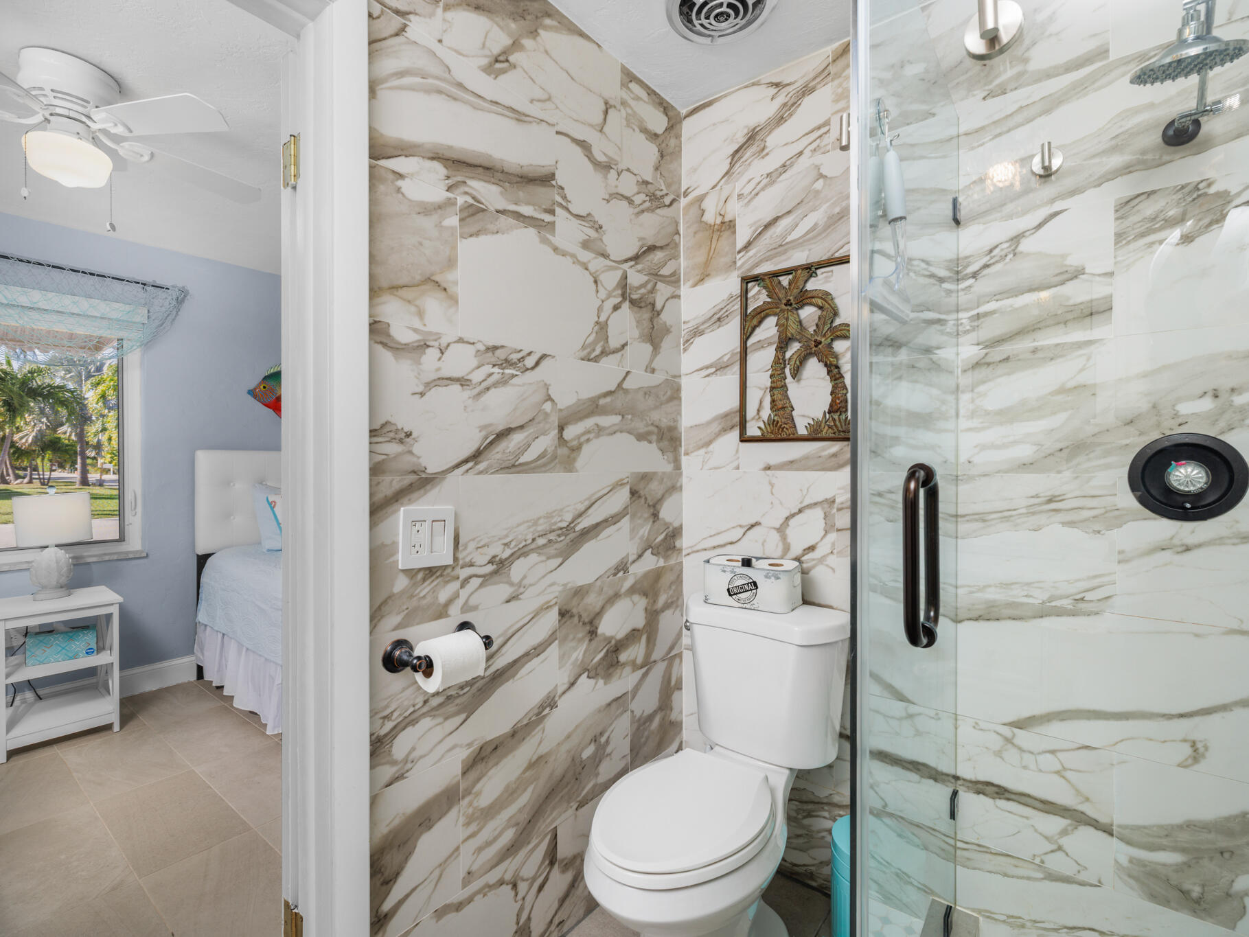 1657 Watson Boulevard Big Pine Key, FL 33043 - Photo 14 of 34 a white toilet sitting next to a bathroom sink