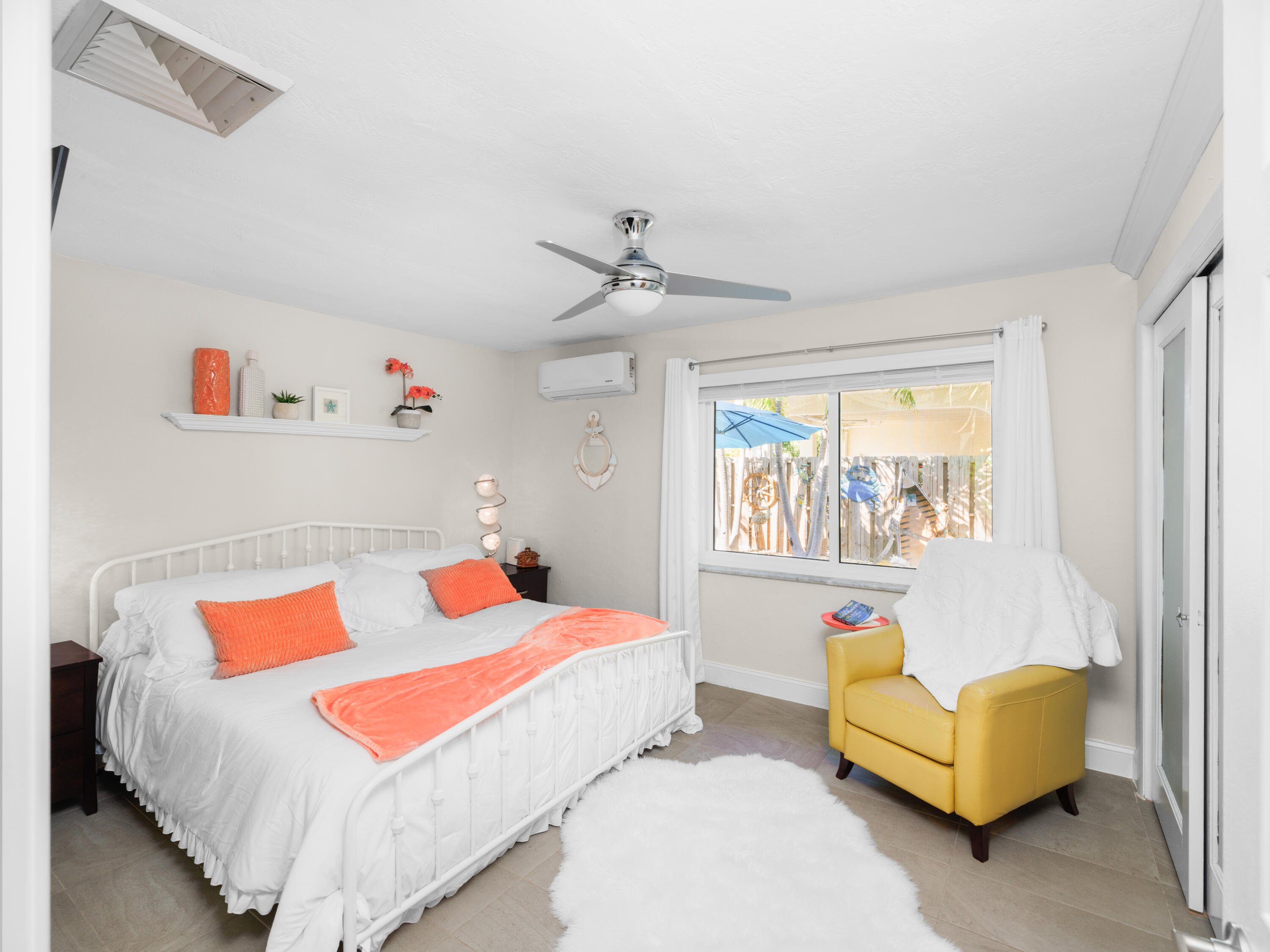 1657 Watson Boulevard Big Pine Key, FL 33043 - Photo 16 of 34 a bedroom with a bed couch and window