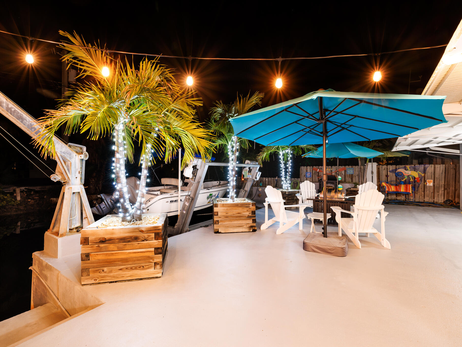 1657 Watson Boulevard Big Pine Key, FL 33043 - Photo 24 of 34 a view of a patio with a table and chairs under an umbrella