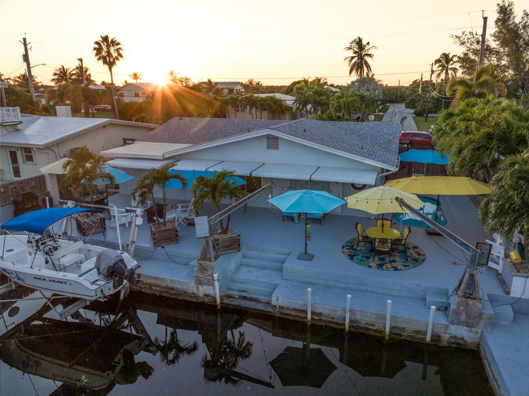 1657 Watson Boulevard Big Pine Key, FL 33043 - Photo 33 of 34 a view of a patio with table and chairs under an umbrella