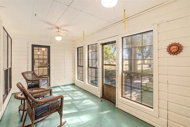 a living room with furniture and a floor to ceiling window