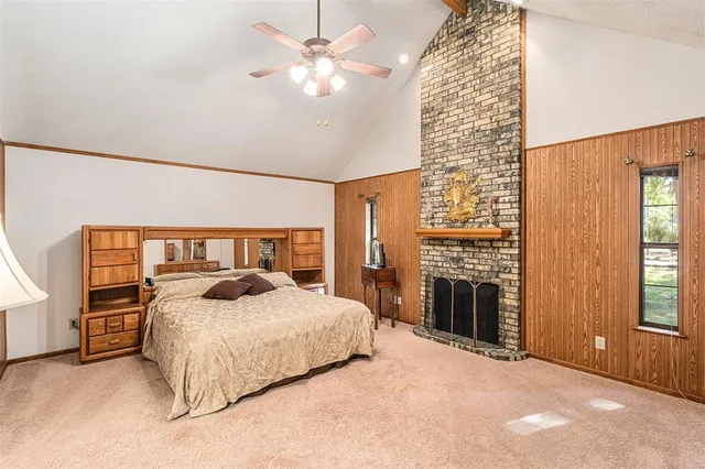a bedroom with a large bed and a chandelier