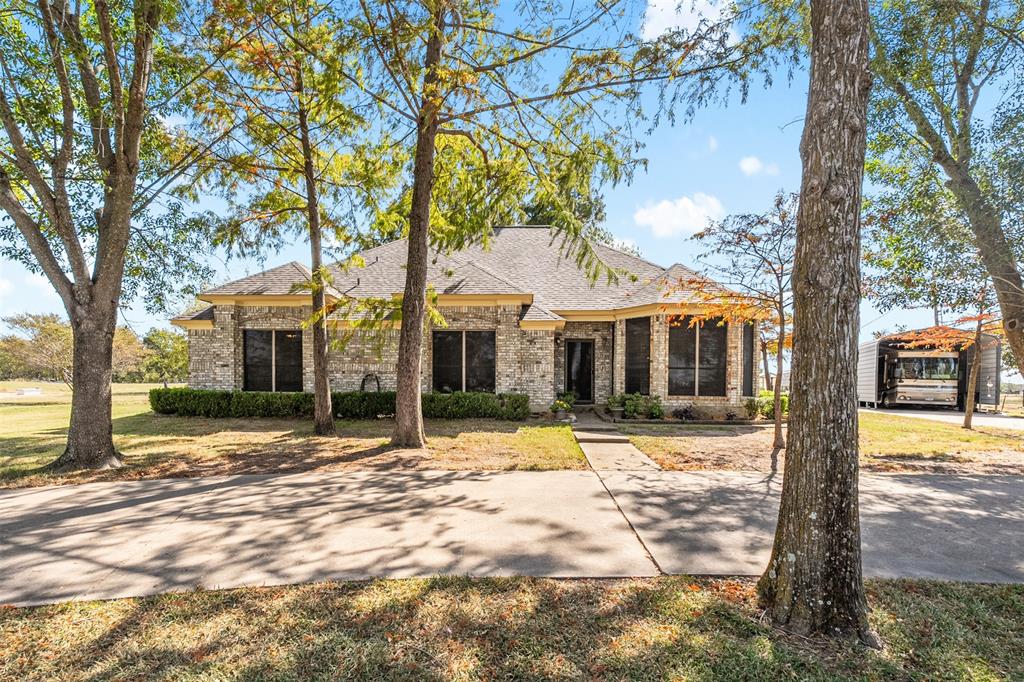 1199 Cedar Lane Kaufman, TX 75142 - Photo 2 of 40 View of front of property with brick siding, a shingled roof, and a front yard