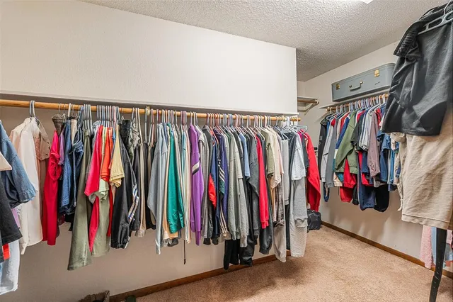 a view of walk in closet with clothes