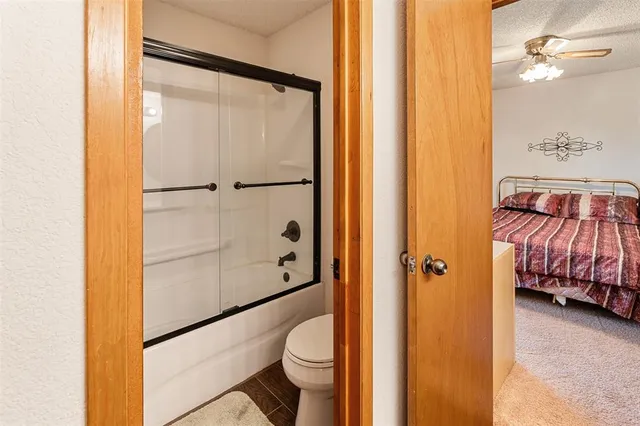 a bathroom with a shower and a toilet