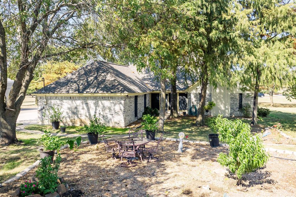 1199 Cedar Lane Kaufman, TX 75142 - Photo 31 of 40 View of back of property with brick siding and roof with shingles