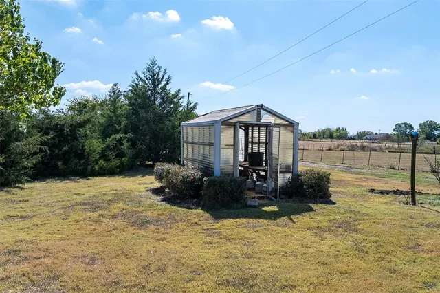 a backyard of a house with table and chairs