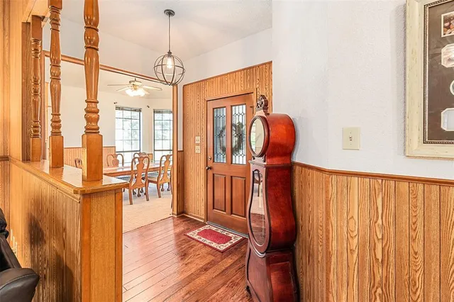 a view of a hallway with wooden floor and entryway