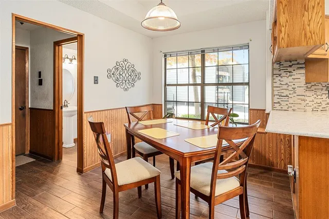 a view of a dining room with furniture and a window