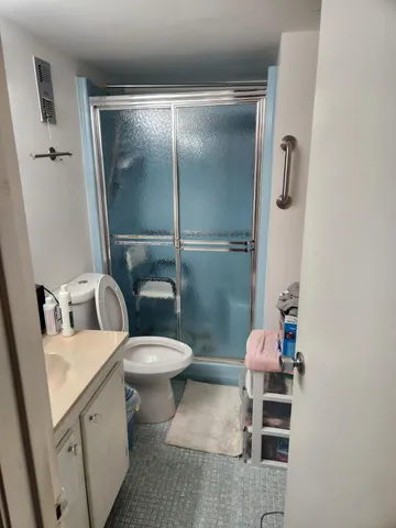 a white toilet sitting next to a bathroom sink