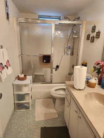 a bathroom with a sink toilet and shower