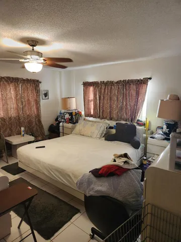 a bed room with a bed window and a chair