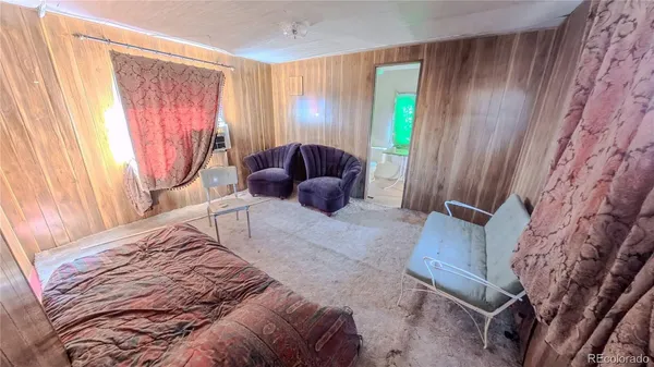 a view of a house with wooden deck and a backyard